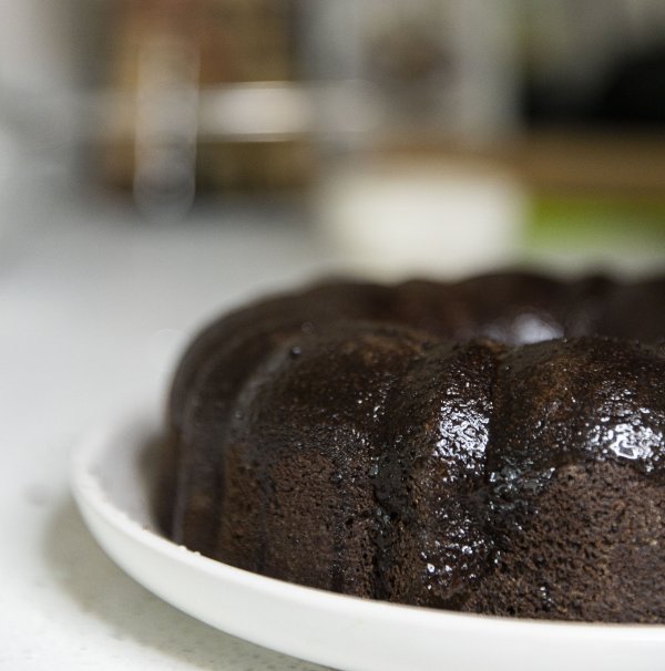 Coating a chocolate cake with a brush