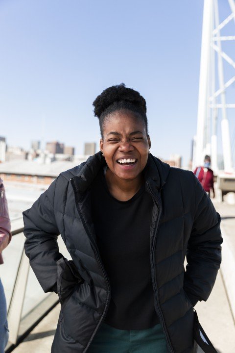 Black woman laughing on nelson Mandela bridge