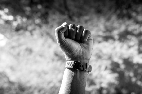 Black and white shot on male fist in sunlight.