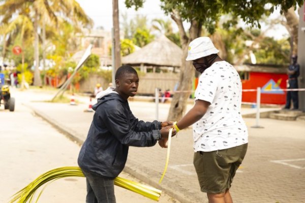 Black boy using tress as bracelets.