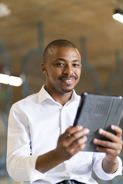 Black business man looking at iPad