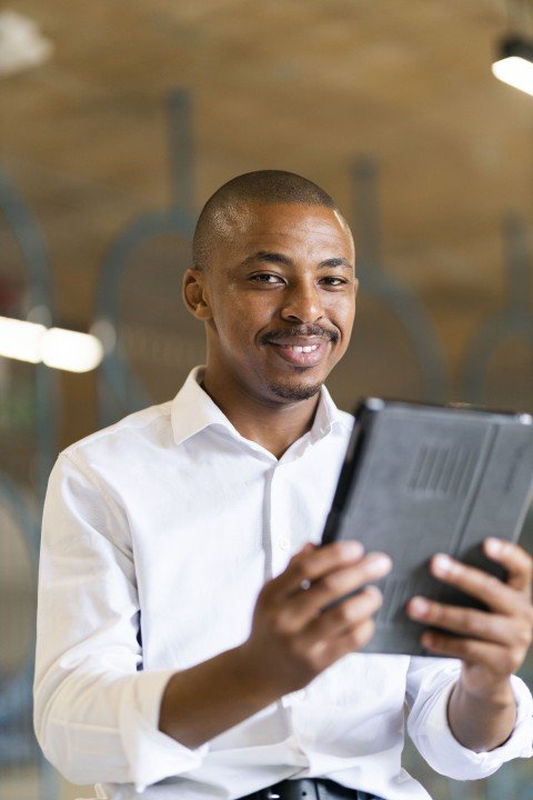 Black business man looking at ipad
