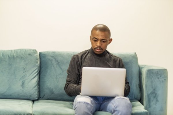 Black man working on his laptop at home