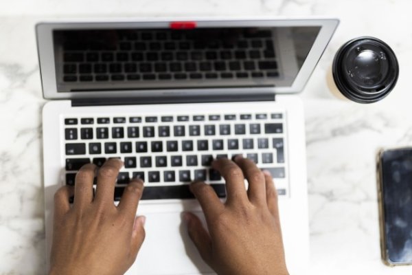 Black hands working on the laptop