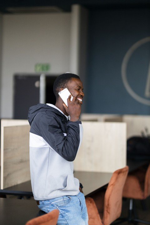 Black man talking on the phone at the office