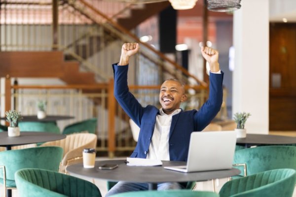 Black business man at work celebrating