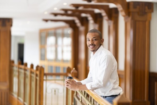 Black business man at work holding coffee