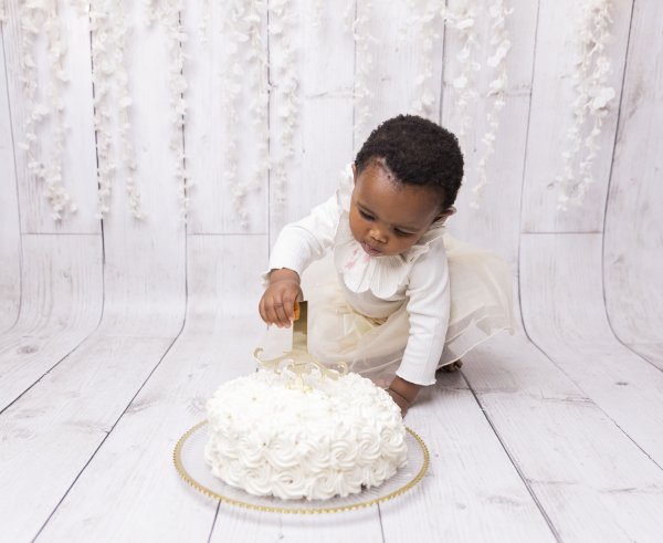 Black child playing with cake