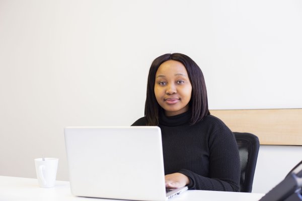 Black corporate woman wearing a mask at the office