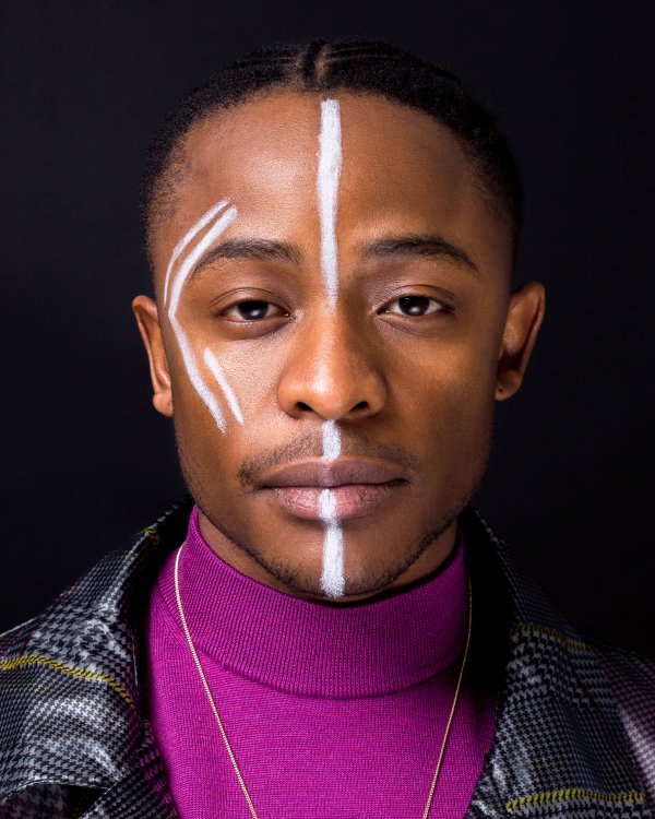 Black male model with paint on the face