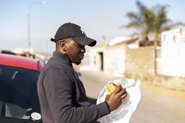 Black man eating a kota
