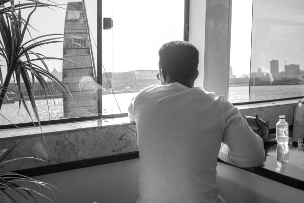 Black man looking over at a boat