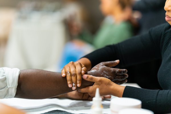 Black woman getting a hand massage