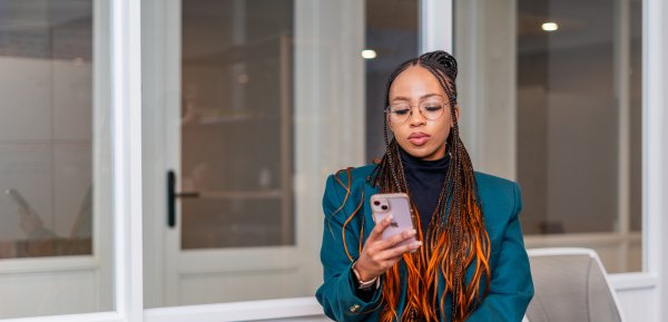 Black woman looking at phone