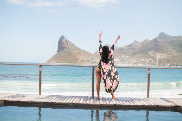 Black woman posing by the ocean in Cape Town
