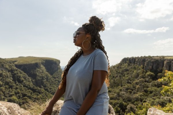 Black woman watching the views of Mpumalanga