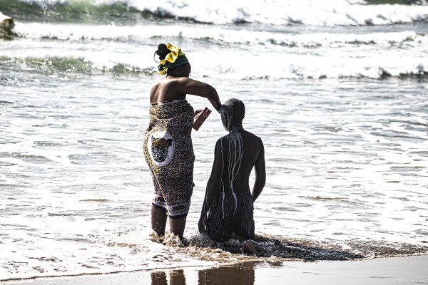 A South African traditional cleansing taking place at the beach with a sangoma