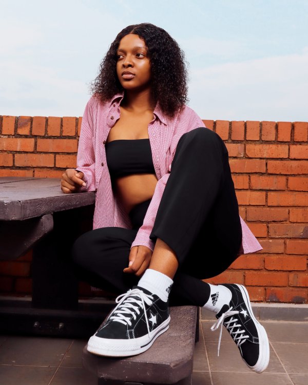 Woman wearing Converse 1 sneakers on rooftop