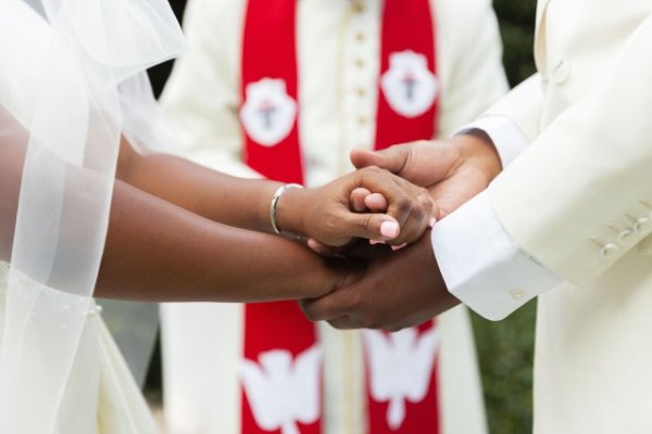 Couple holding hands at their wedding