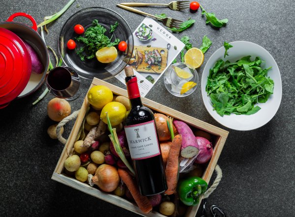 flatlay of vegetables on a table with wine