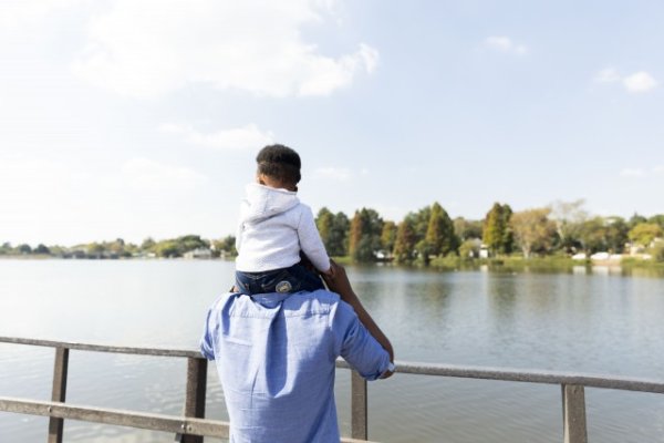 Father and son by the dam