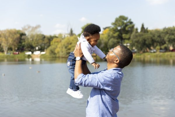 Father and son by the dam together enjoying themselves