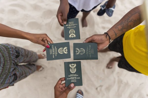 Friends holding South African passports