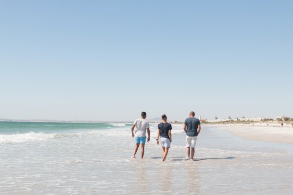 Friends walking at the beach