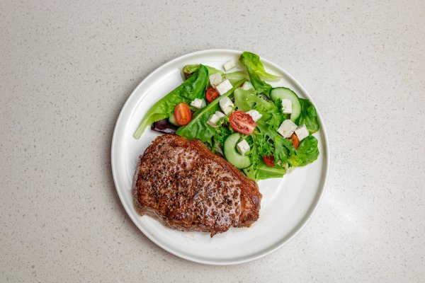 Beef steak and a classic salad with tomatoes