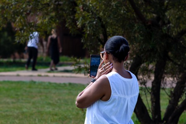 Lady wearing white on a sunny day  taking a selfie