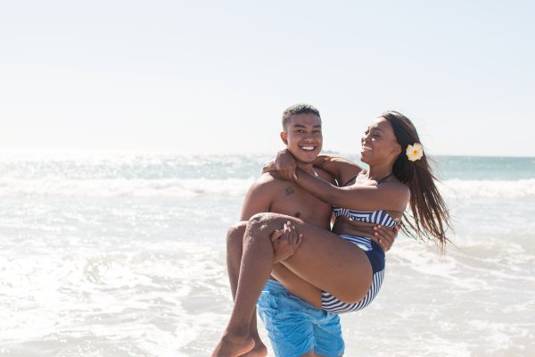 Lovers laughing at the beach