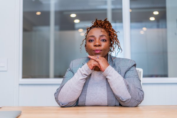 Mature black business woman looking at camera at work.