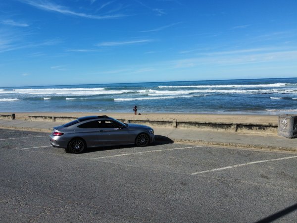 Mercedes Benz C200 in front of the beach