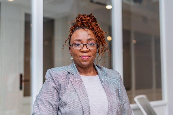 Portrait of mature black business woman at the office wearing glasses.