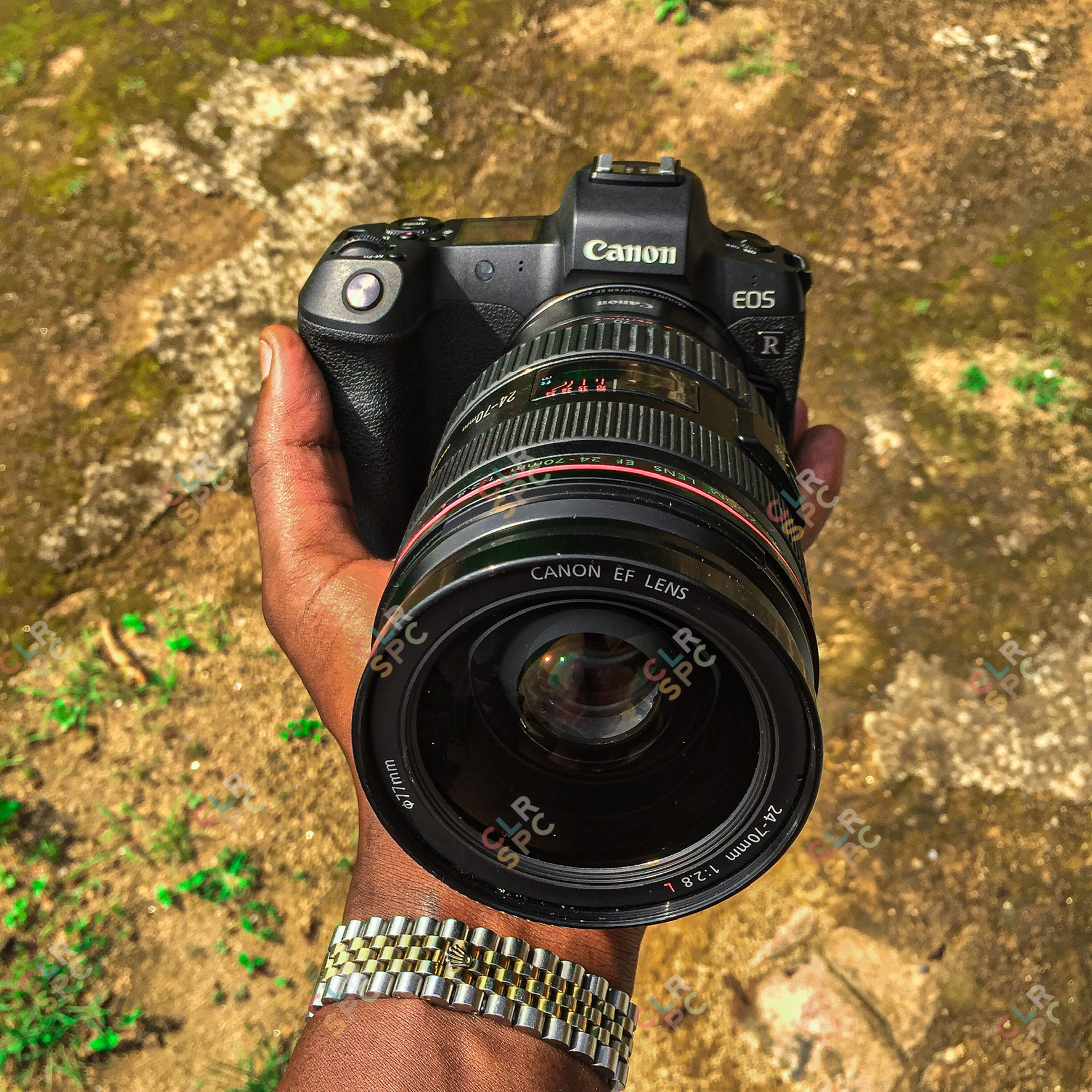 Holding a canon EOS R Camera