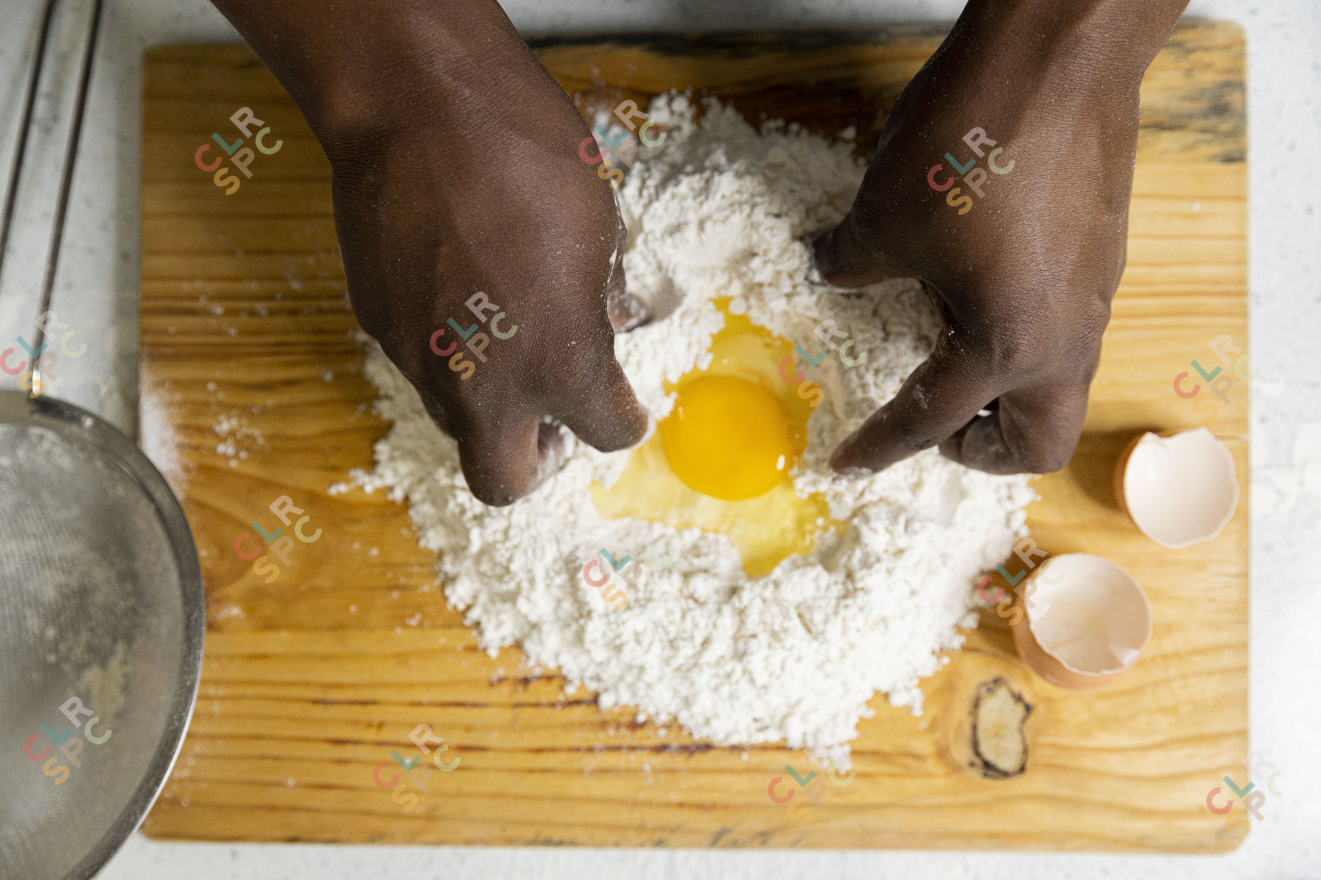 Mixing eggs inside flour