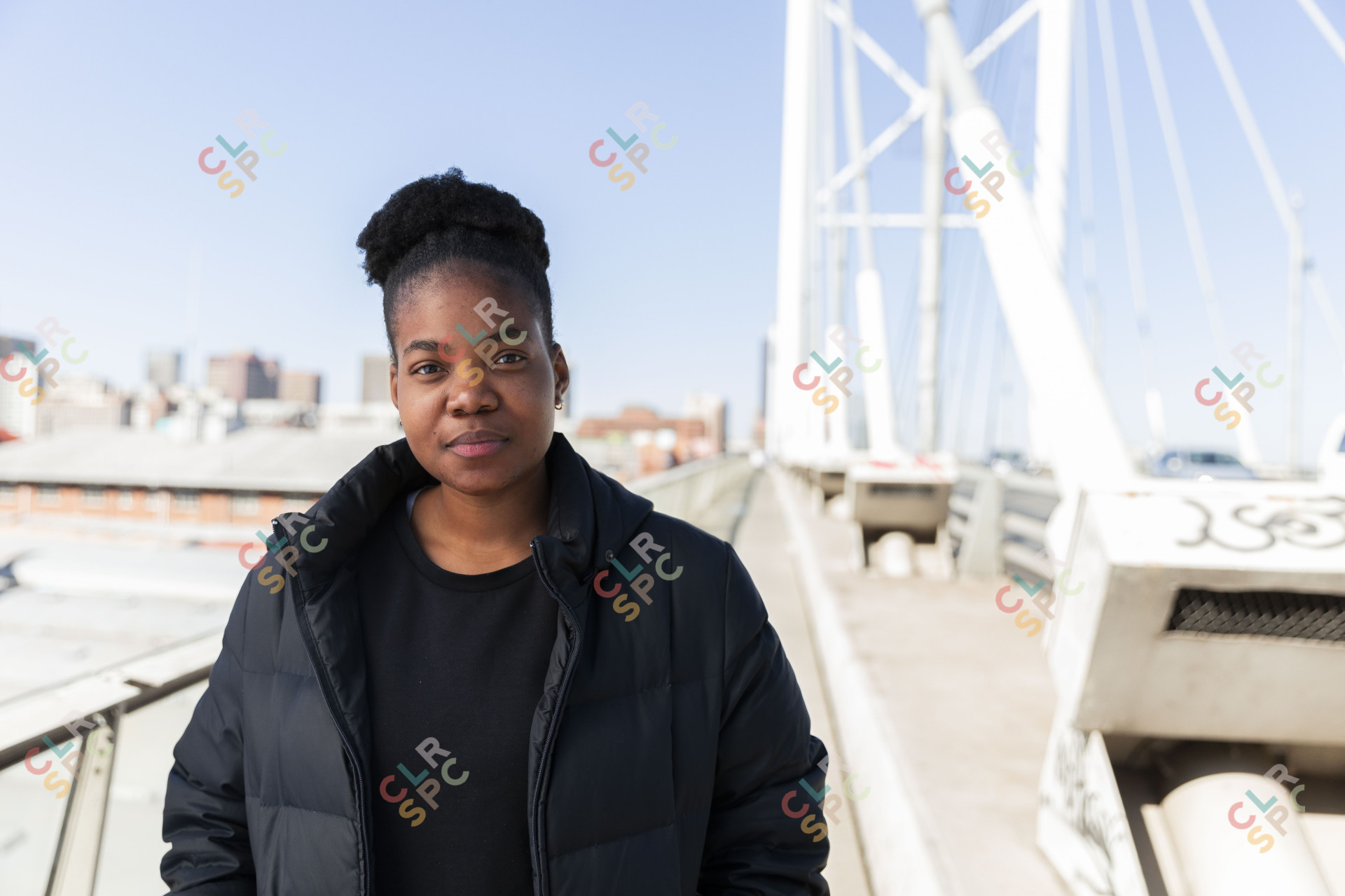 Black woman wearing all black on Nelson Mandela bridge