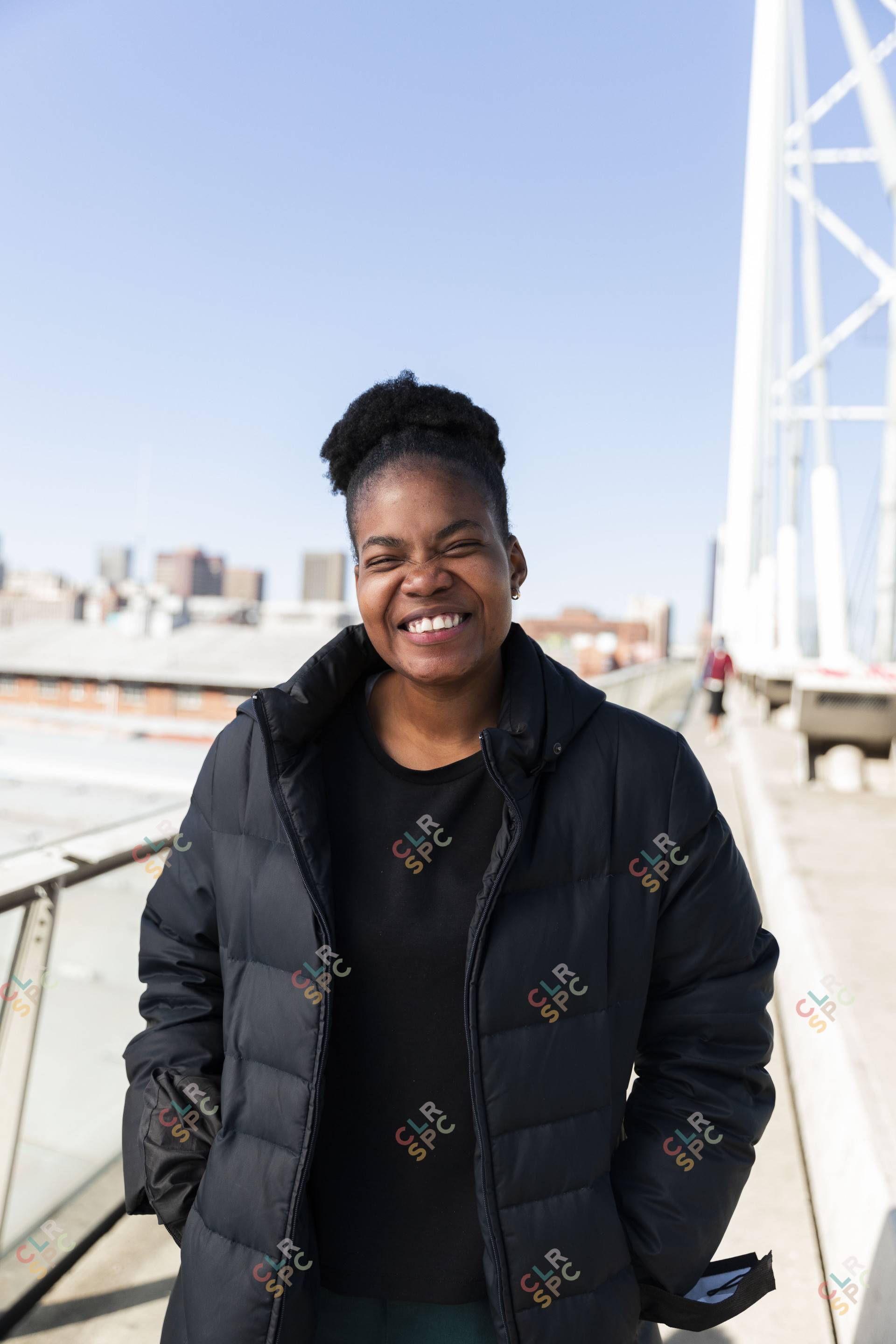 Black woman wearing all black grinning
