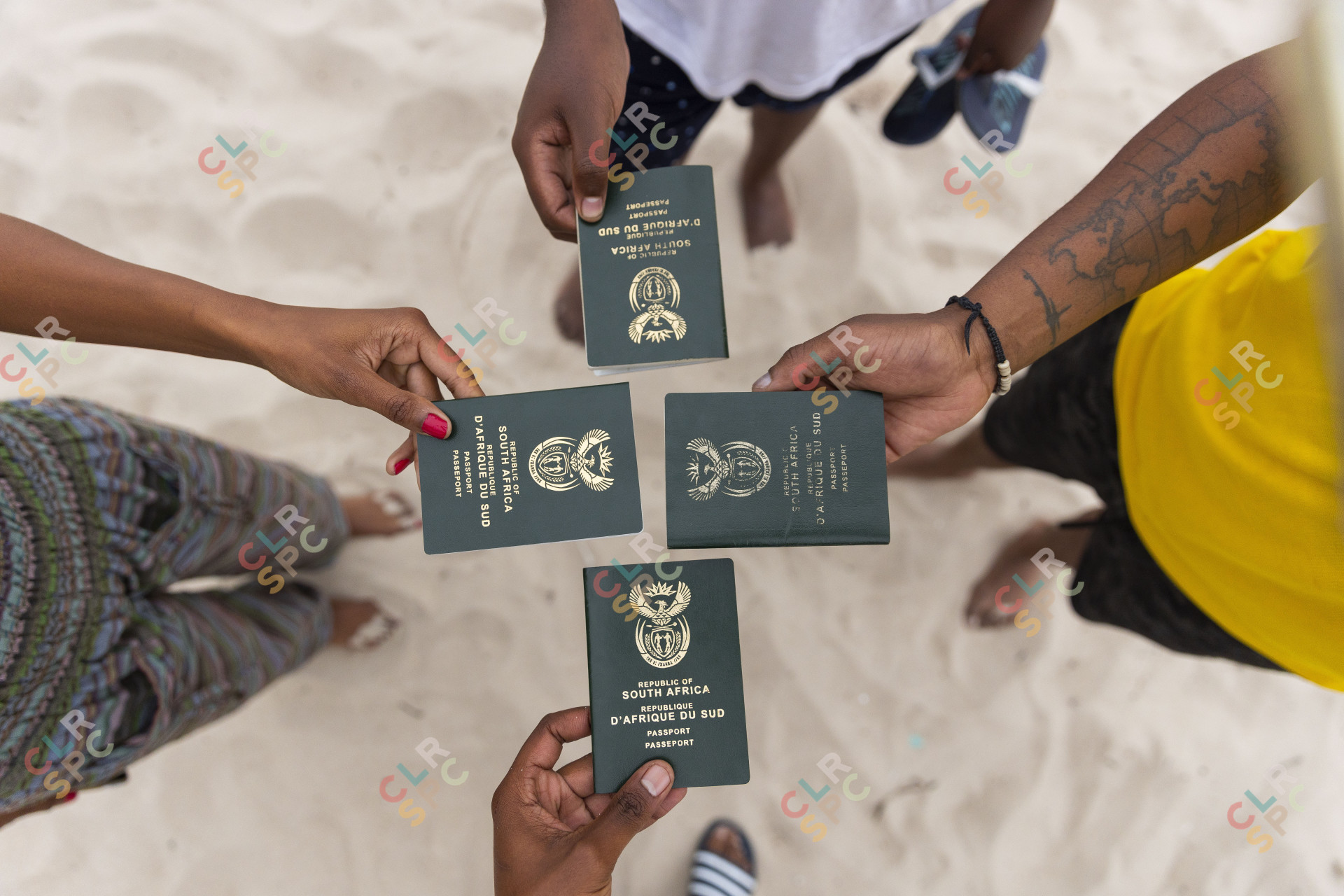 Friends holding South African passports
