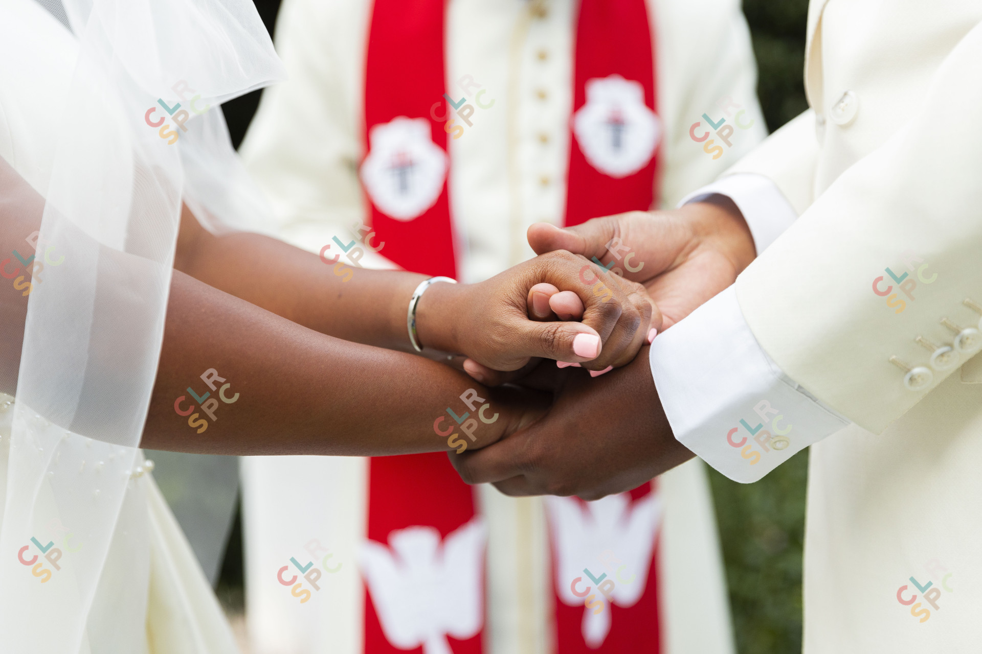 Couple holding hands at their wedding