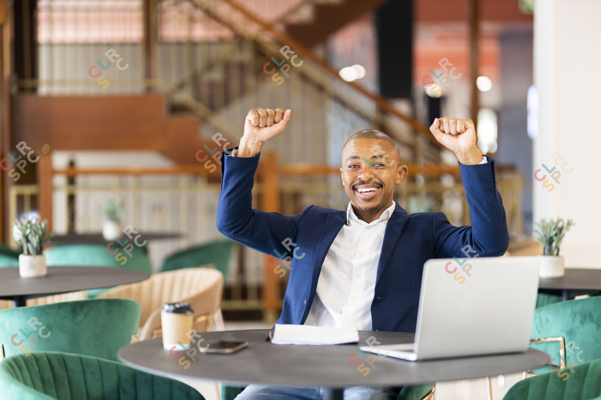 Black business man  celebrating with arms in the air