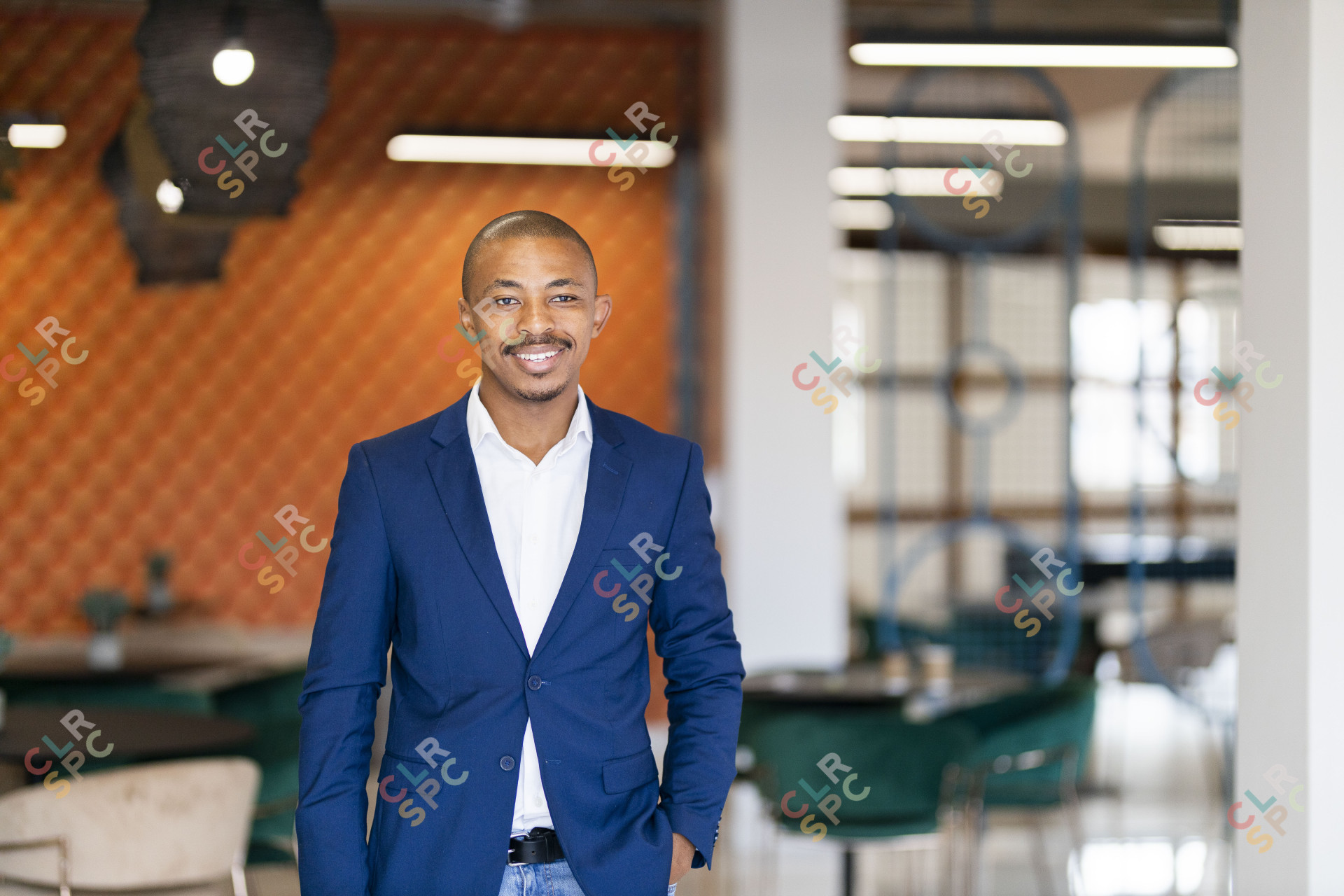 Black business man wearing a suit and smiling at the office