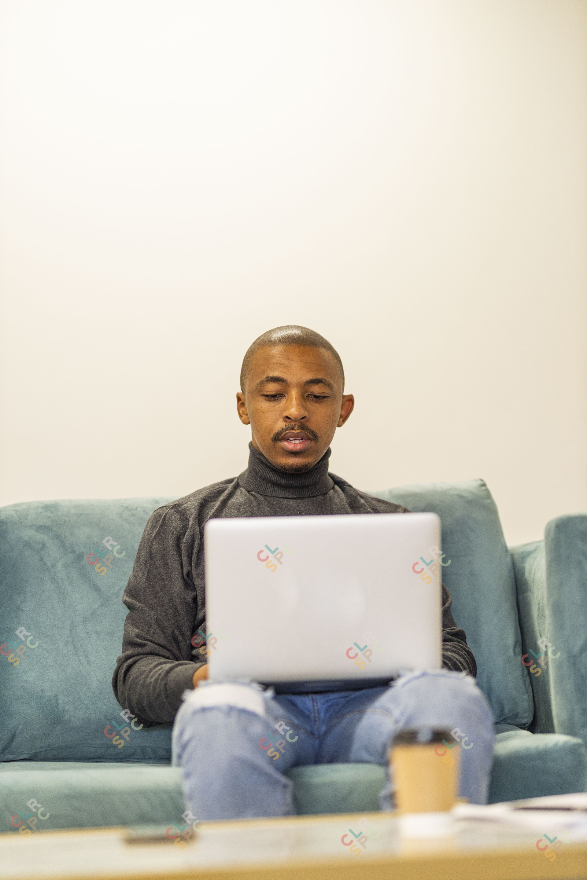 Black man working on his laptop at home