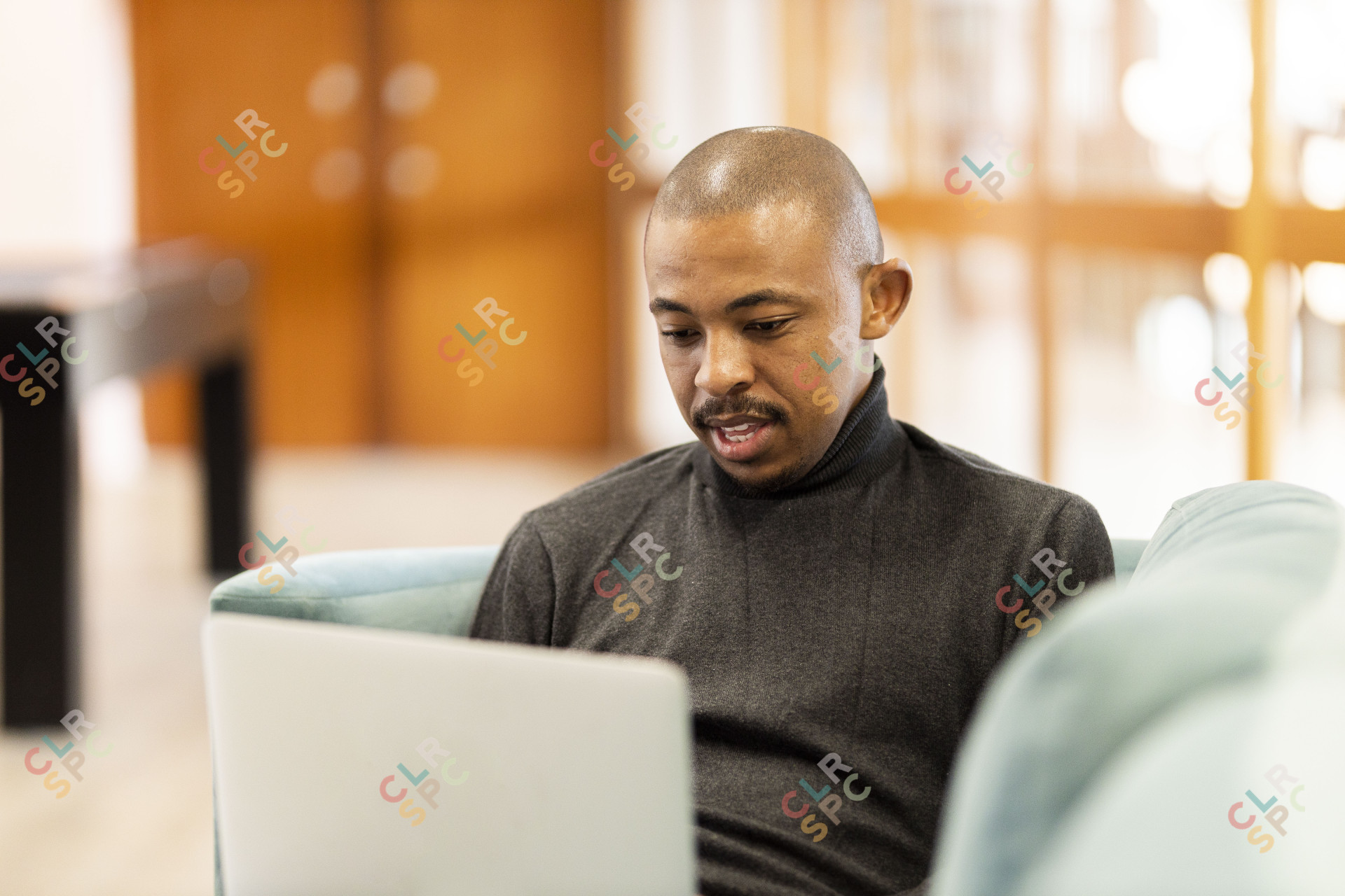 Black man working on his laptop at home