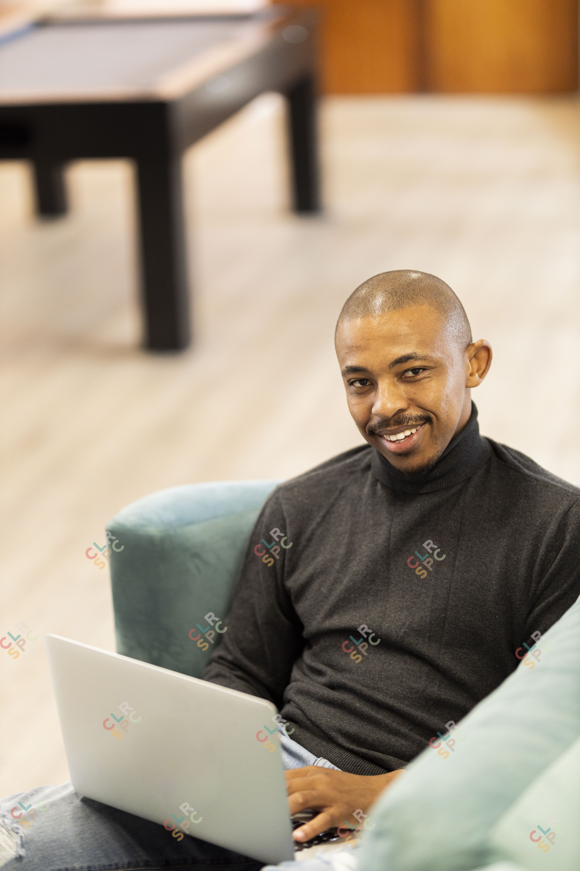 Black man working on his laptop at home
