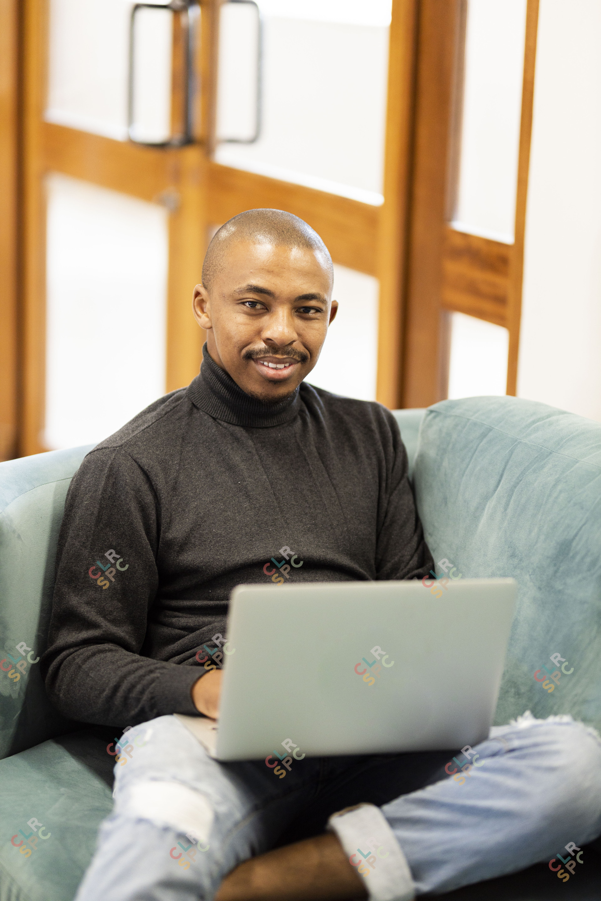 Black man working on his laptop at home