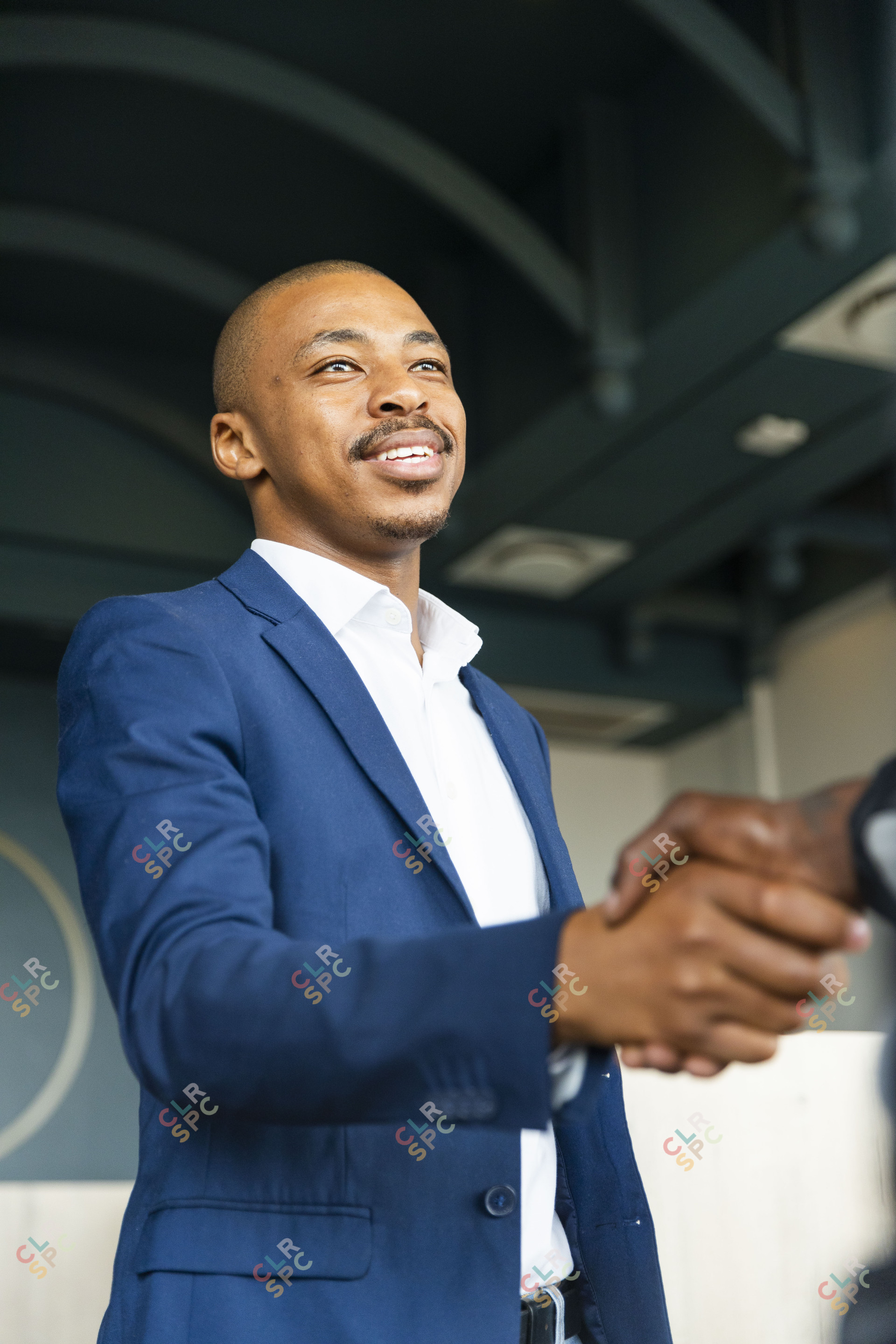 Black business man hand shaking hands with a client at work and smiling