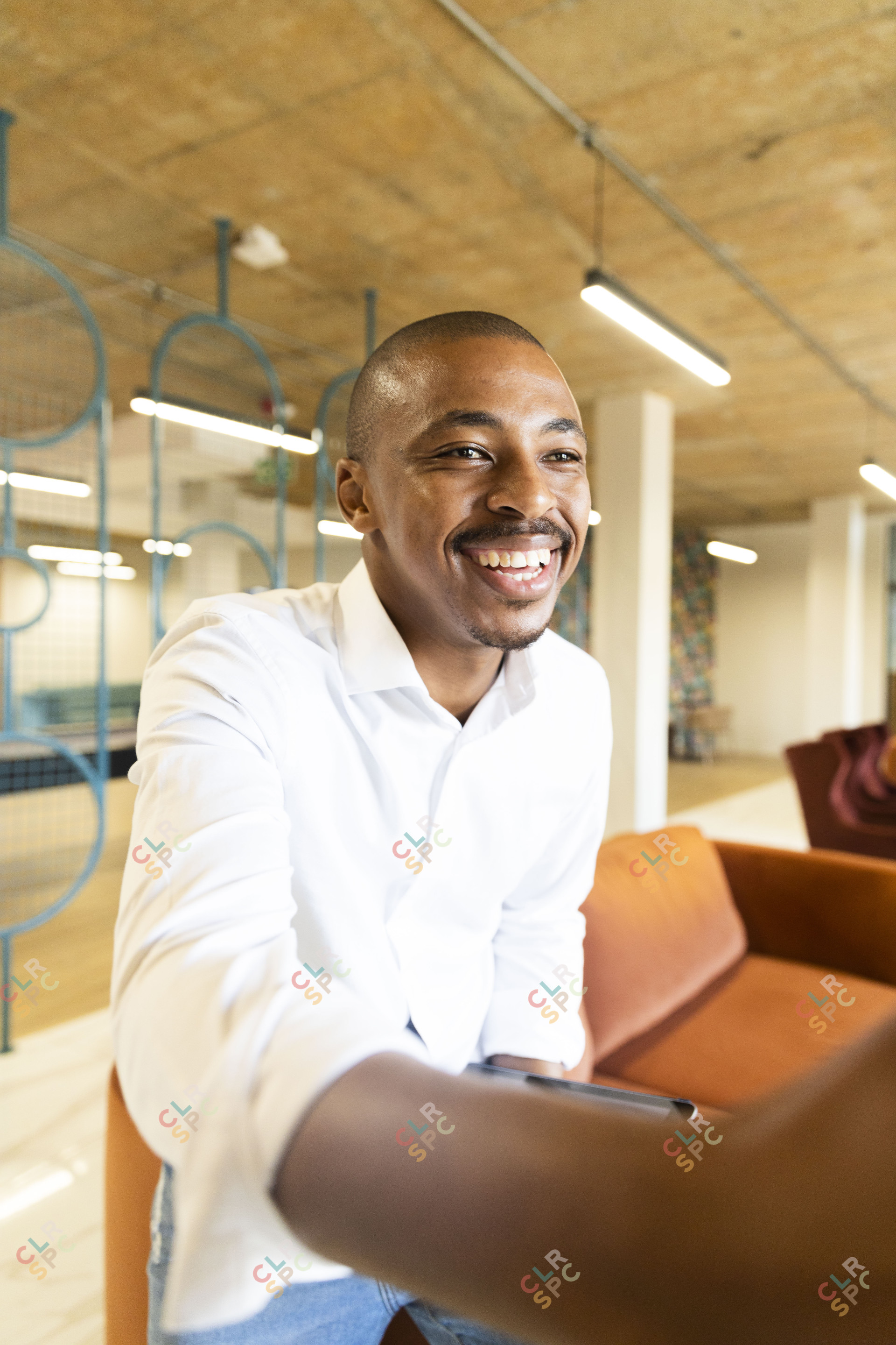 Black business man approaching to shake hands with a client at work smiling