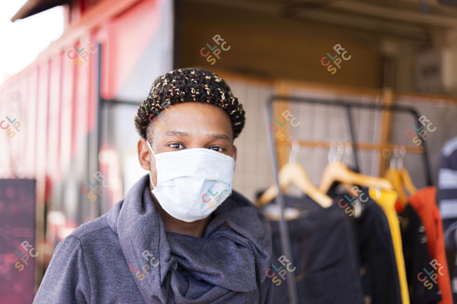 Black man wearing mask with beanie