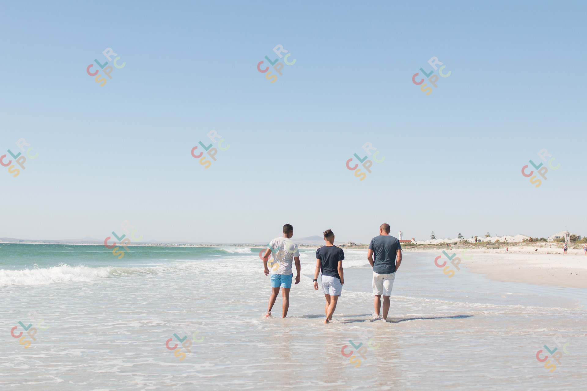 Friends walking at the beach